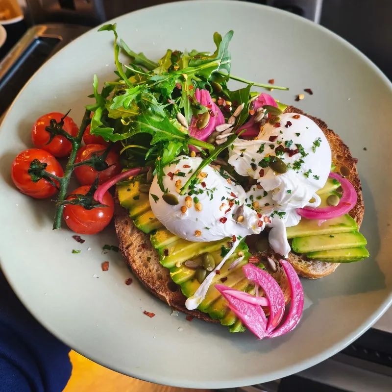 Avocado sourdough with poached eggs and pickled onion